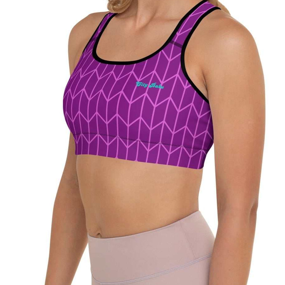 A close-up of The New York Performance Bra, showing the "City Babe" text on the purple Art Deco print.
