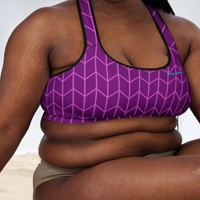 A close-up of The New York Performance Bra, showing the "City Babe" text on the purple Art Deco print.
