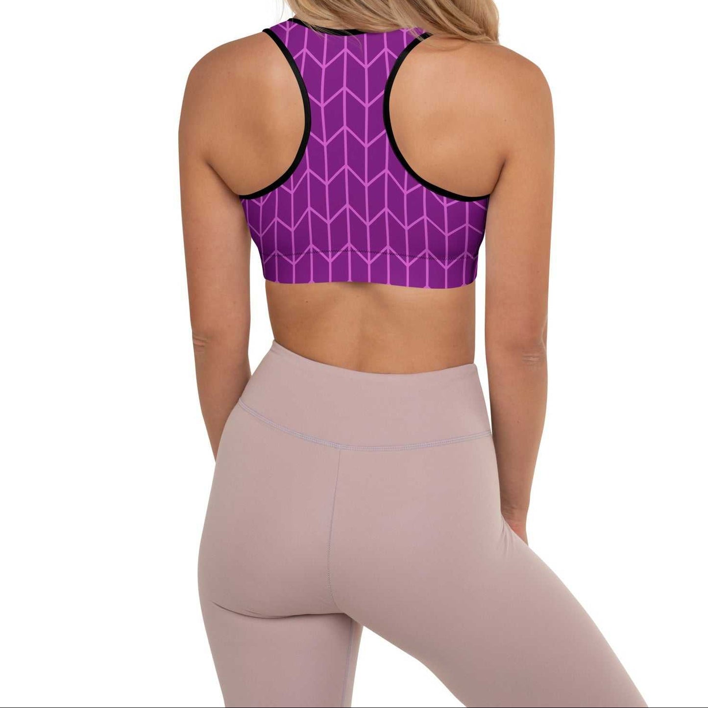 A close-up of The New York Performance Bra, showing the "City Babe" text on the purple Art Deco print.