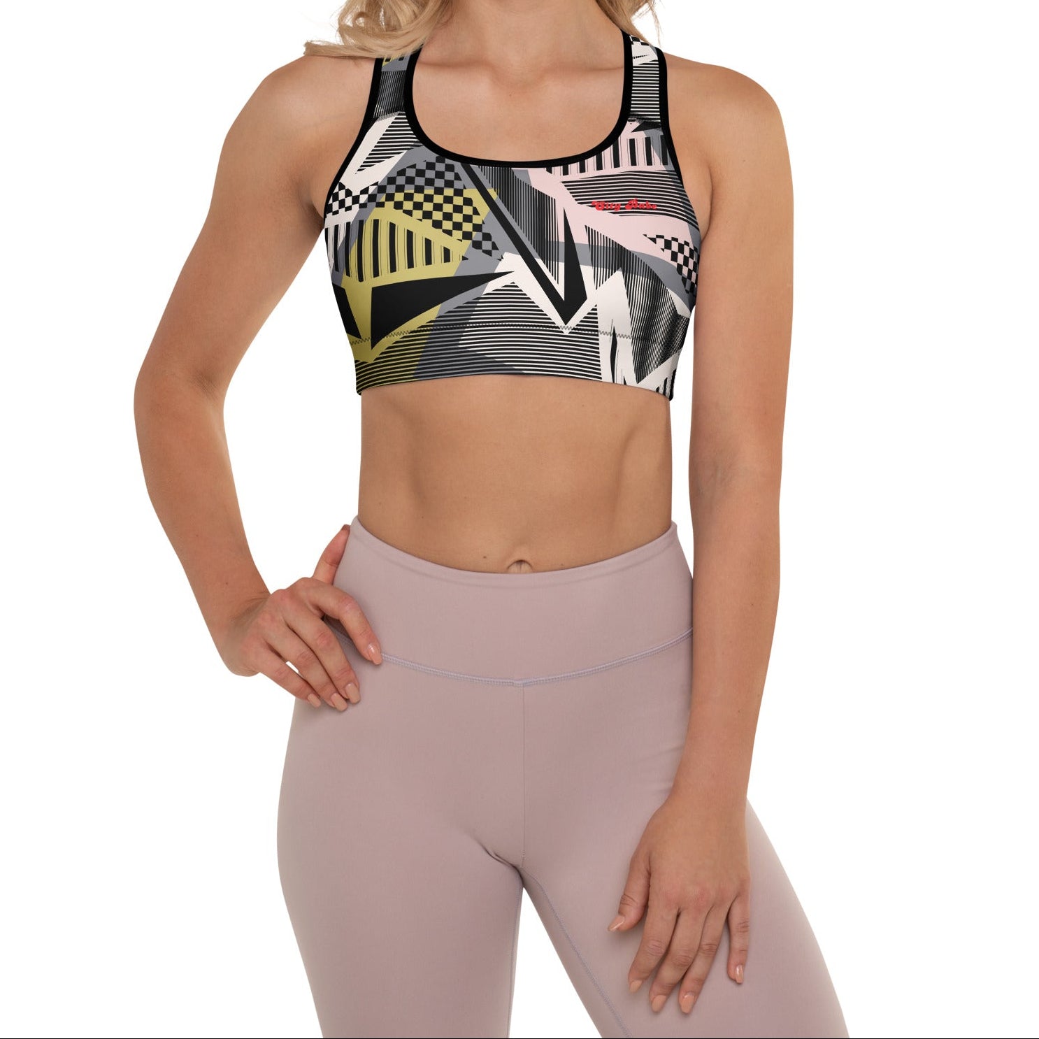 Model wearing the Oxford Performance Bra  by BunnyBanky, featuring a striking abstract design with black, pink and yellow geometric shapes