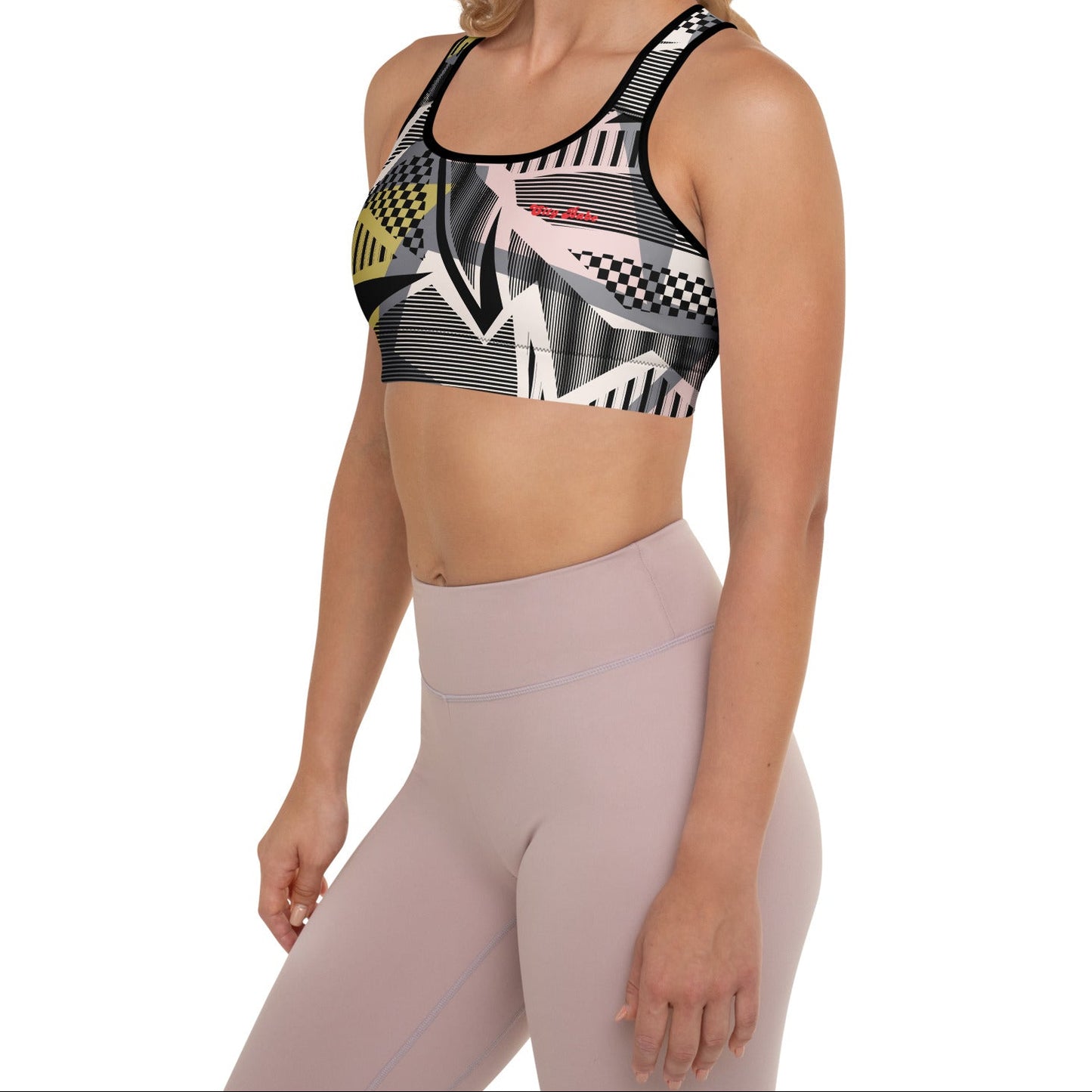 Model wearing the Oxford Performance Bra  by BunnyBanky, featuring a striking abstract design with black, pink and yellow geometric shapes