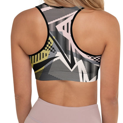 Model wearing the Oxford Performance Bra  by BunnyBanky, featuring a striking abstract design with black, pink and yellow geometric shapes