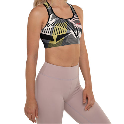 Model wearing the Oxford Performance Bra  by BunnyBanky, featuring a striking abstract design with black, pink and yellow geometric shapes