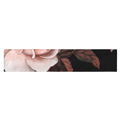 The Paris headband is an elastic featuring a floral print with pale pink and white flowers on a solid black background.