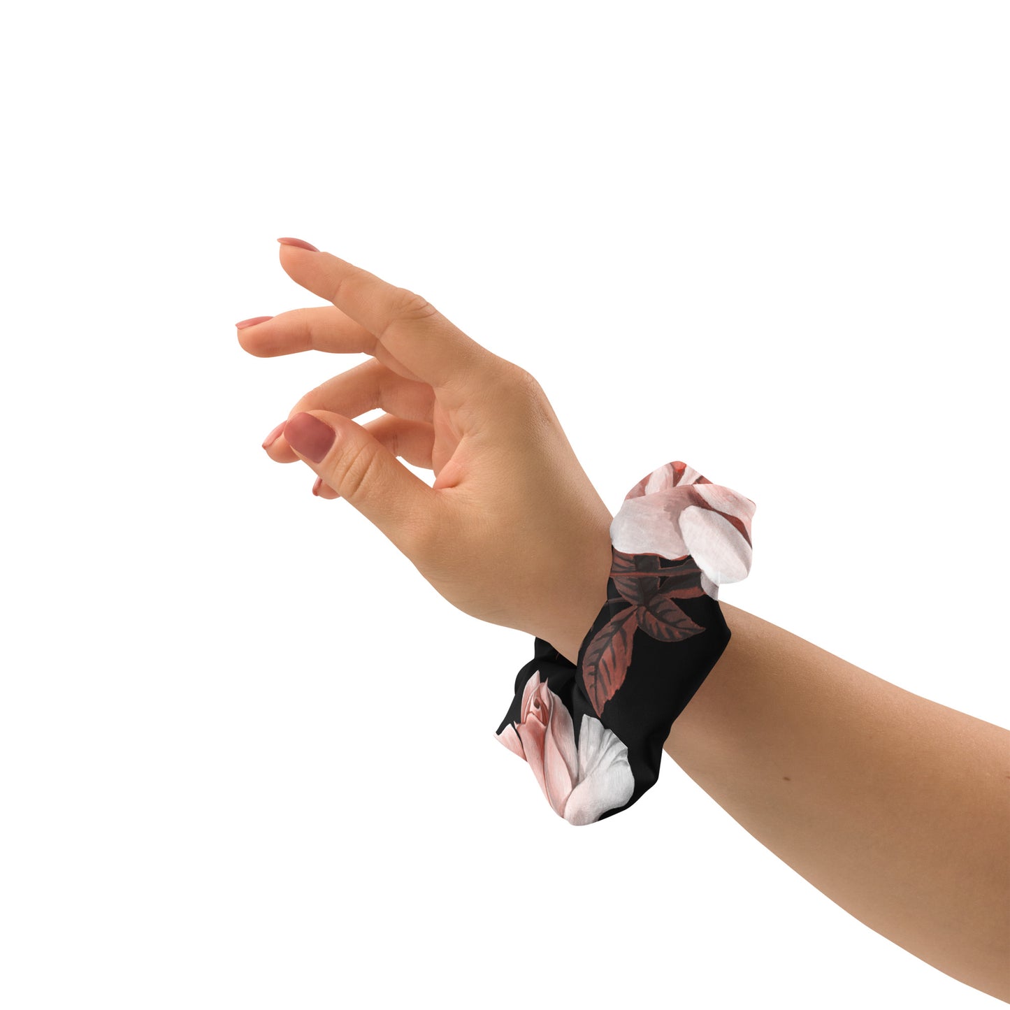 The Paris Scrunchie.A recycled fabric hair scrunchie with a black base and a pink and white floral print, and removable bow shown being worn on a person's hand against a plain white background.