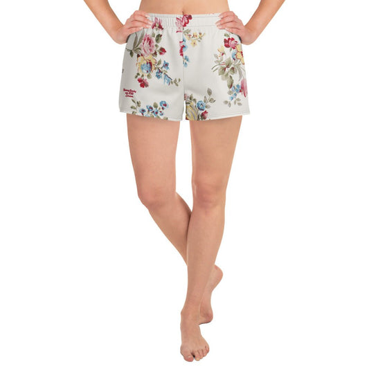 model wearing the Pink Blush Athletic Shorts, highlighting the delicate pink and sky blue floral print and the athletic 2.5″ inseam.