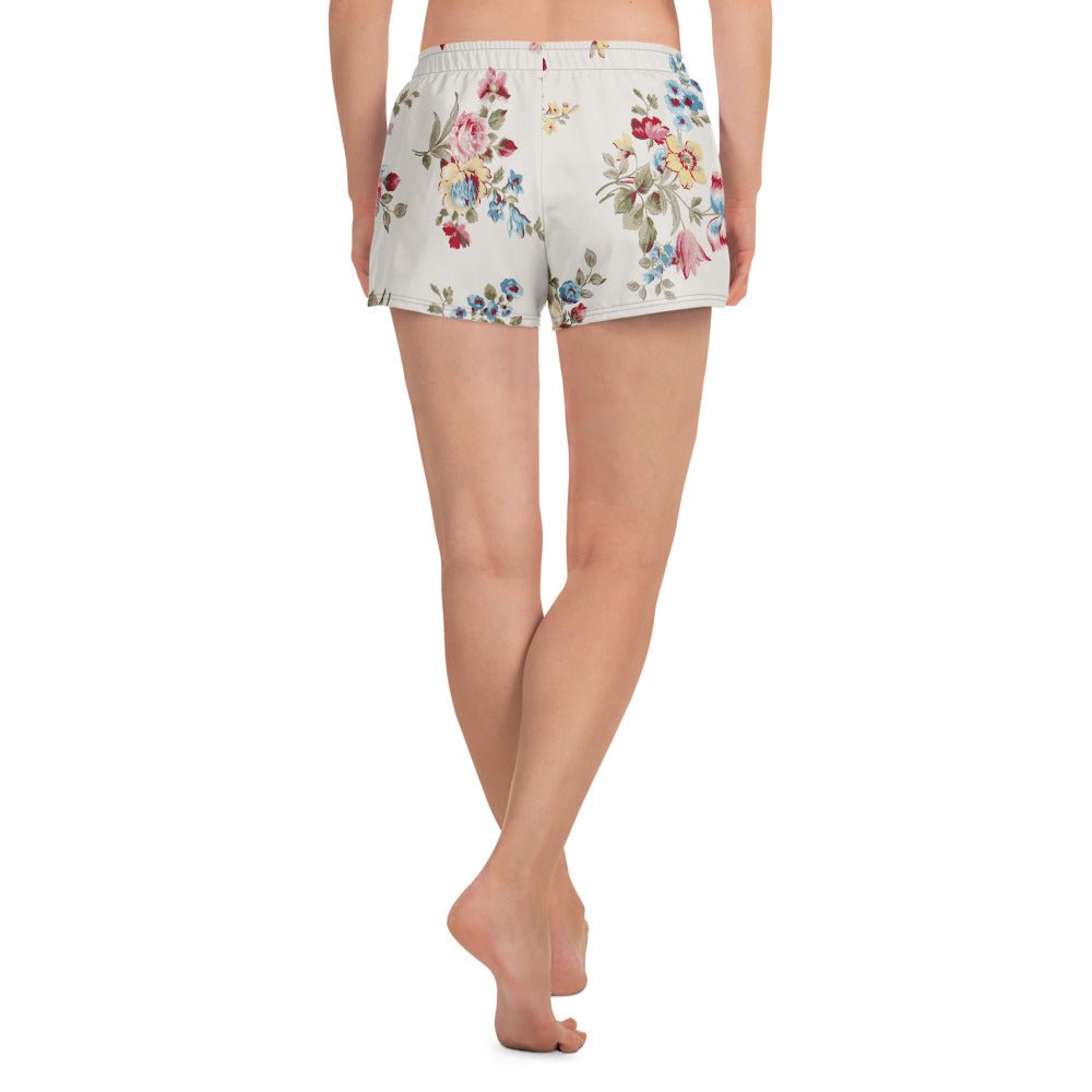 model wearing the Pink Blush Athletic Shorts, highlighting the delicate pink and sky blue floral print and the athletic 2.5″ inseam.