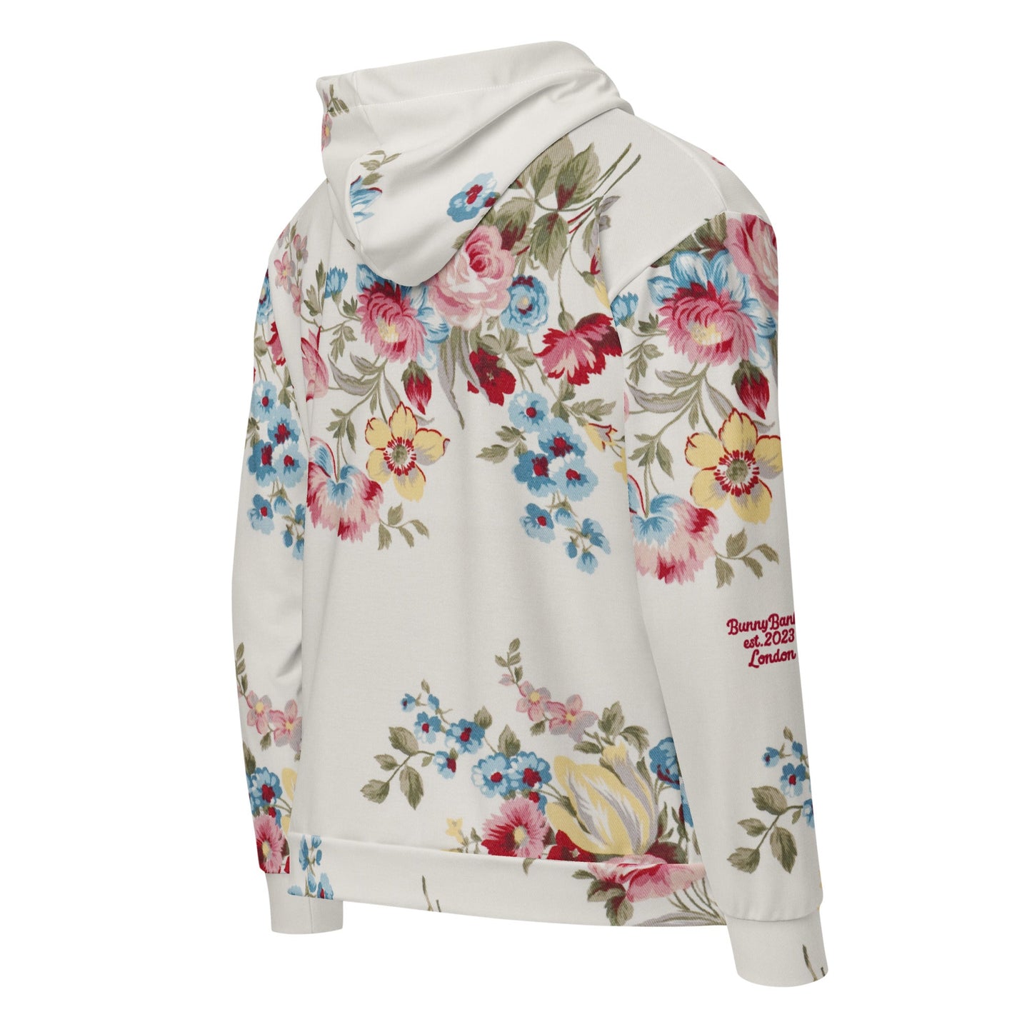 Close-up of The Pink Blush Zip Hoodie fabric, highlighting the textured, off-white base, the delicate floral print detail, and the soft texture of the 95% recycled polyester.