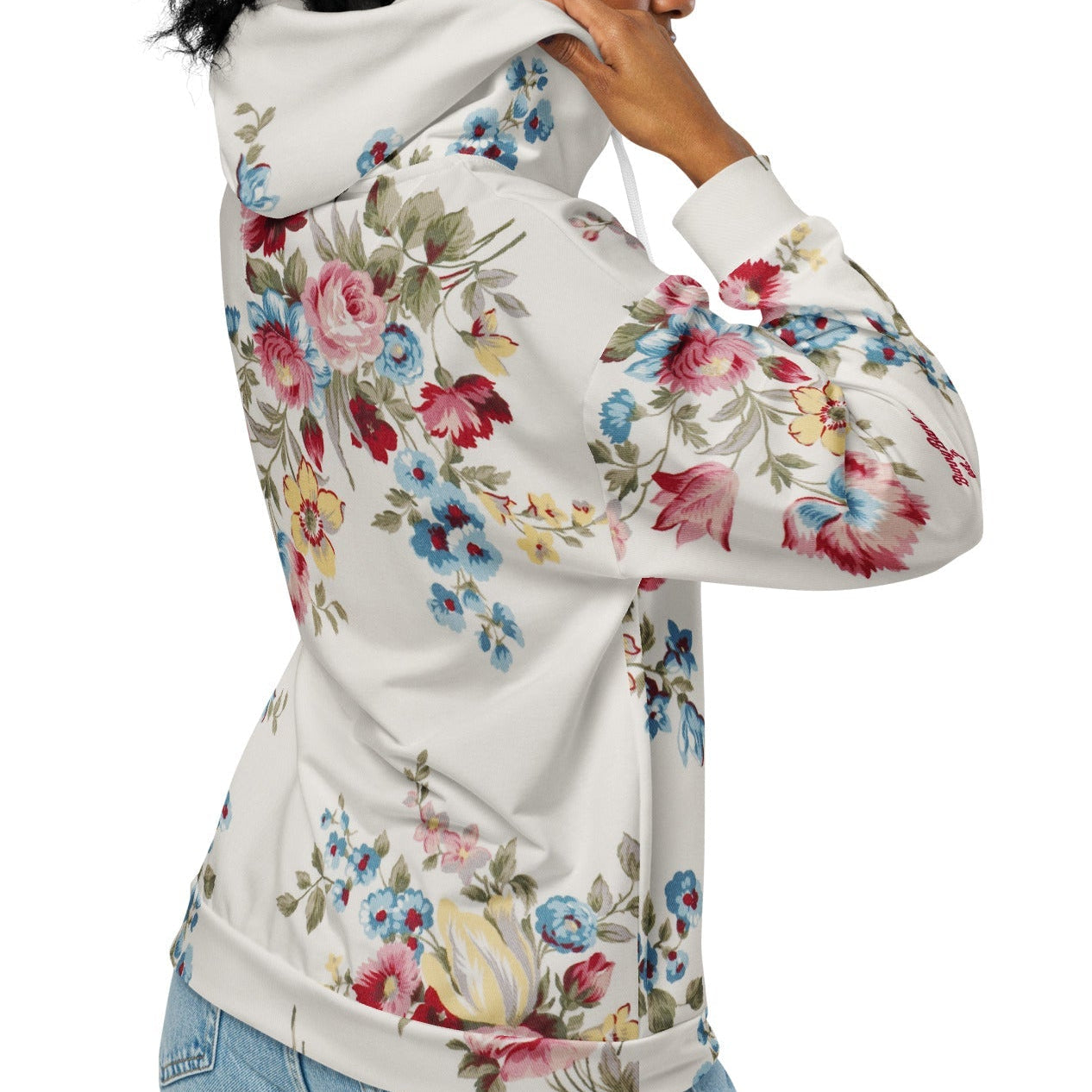 A model wearing The Pink Blush Zip Hoodie, showing the serene pink blush and sky blue floral pattern and the premium fit with metal zipper details.