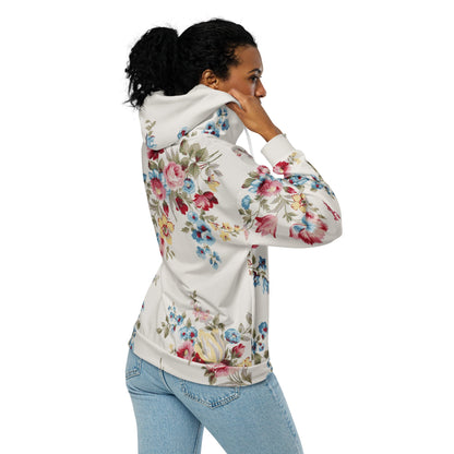 A model wearing The Pink Blush Zip Hoodie, showing the serene pink blush and sky blue floral pattern and the premium fit with metal zipper details.