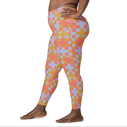 A model wearing the high-waisted Pixel Glam Sculpt Leggings, highlighting the colorful terracotta, gold, and blue pixelated grid pattern and the integrated side pocket design.