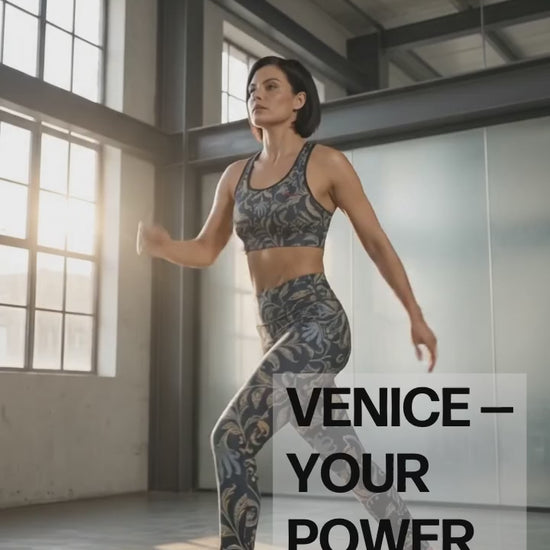 a video showing A model transitioning outfits from the venice sculpt leggings and matching performance bra to wearing a beige trench coat  and underneath the Venice slim fit high-waisted athletic joggers and matching sweatshirt with a dark navy blue background and an intricate botanical pattern in gold, beige, and light blue. The joggers feature a small red logo on the left hip. 
