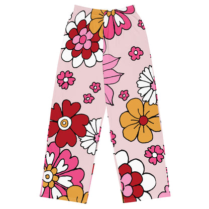 the primrose hill flow joggers. pink wide-leg pants with a retro floral print, styled with a white crop top and white sneakers against a plain white background.