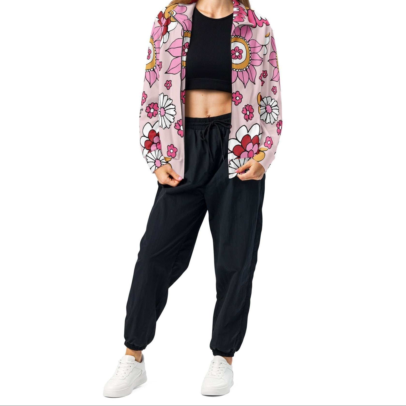 A model wearing The Primrose Hill Track Jacket, showing the lightweight fit and the vibrant pink and yellow oversized floral print.