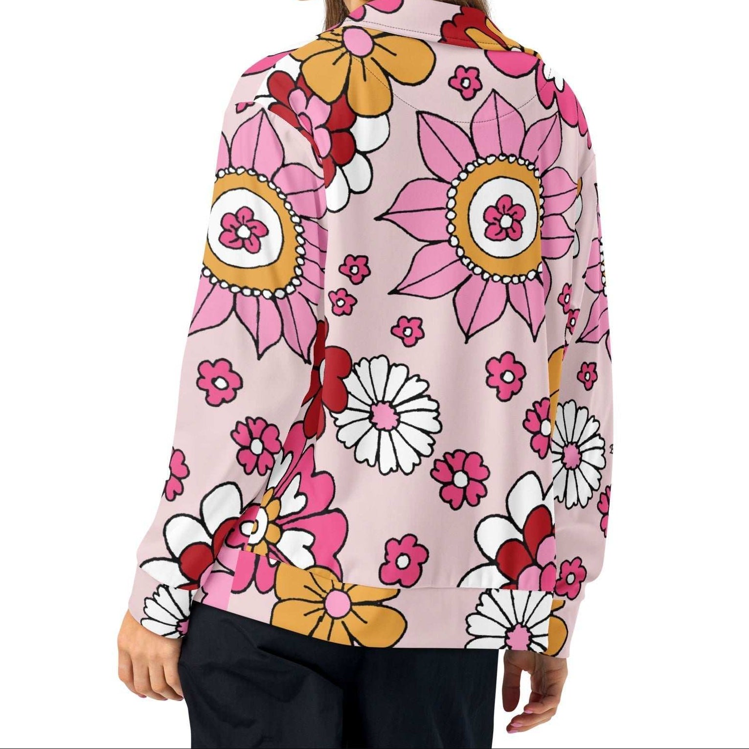 A model wearing The Primrose Hill Track Jacket, showing the lightweight fit and the vibrant pink and yellow oversized floral print.