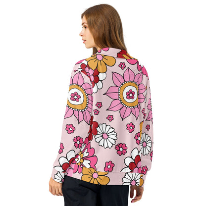 A model wearing The Primrose Hill Track Jacket, showing the lightweight fit and the vibrant pink and yellow oversized floral print.