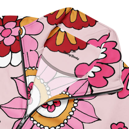 A close-up of The Primrose Hill Track Jacket's recycled polyester fabric, highlighting the texture and the intricate, oversized pink and yellow floral print detail.