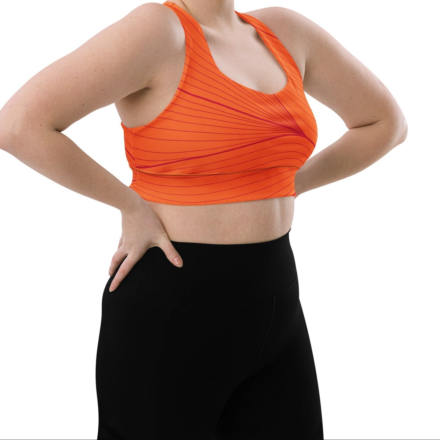 Model wearing the Rhodes Longline Performance Bra in vibrant orange geometric lines on orange background with the iconic logo and signature print at the back