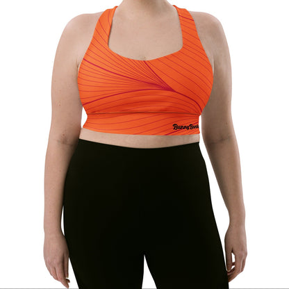 Model wearing the Rhodes Longline Performance Bra in vibrant orange geometric lines on orange background with the iconic logo and signature print at the back