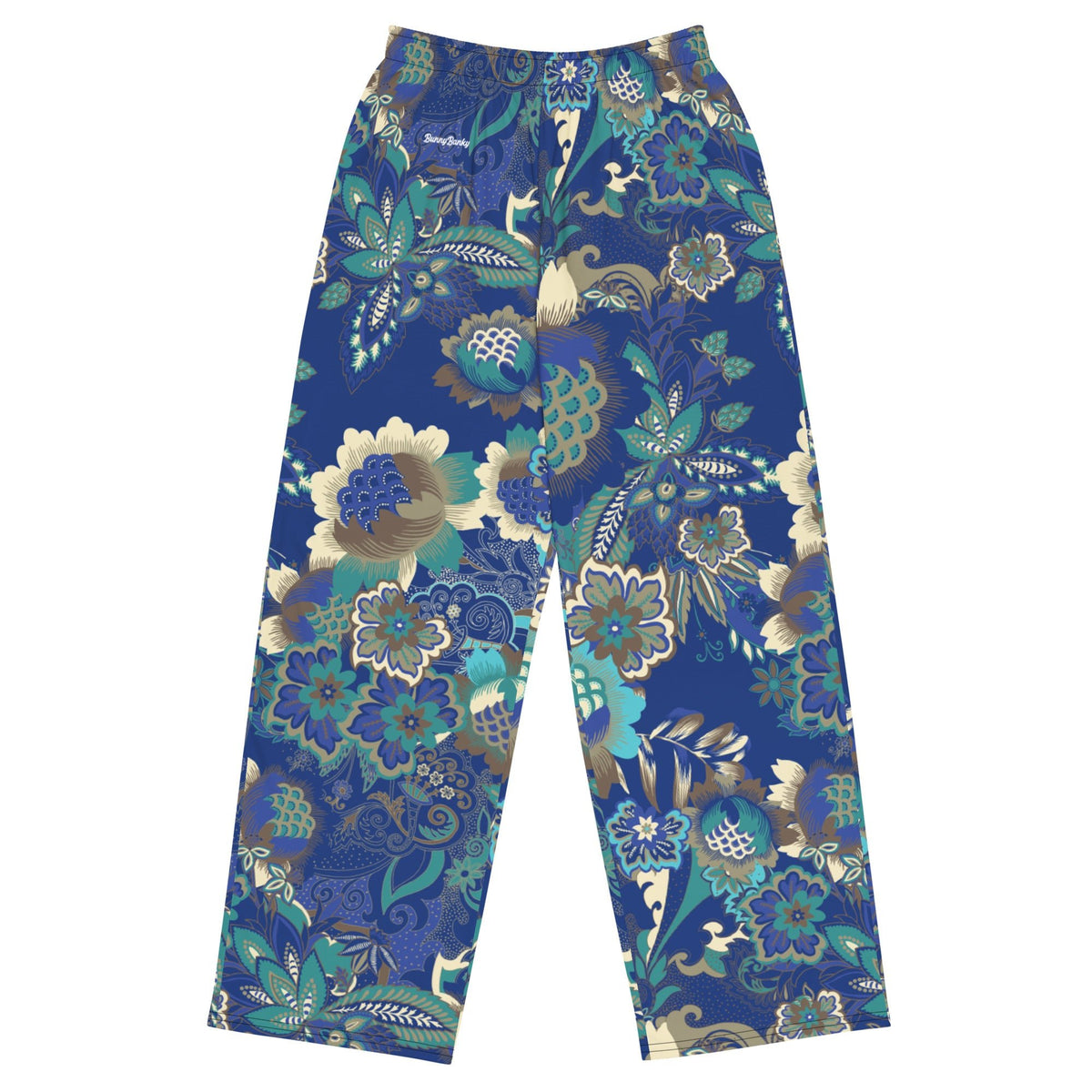 the rio flow joggers, wide-leg cut with a detailed botanical pattern in blue, green, and gold, paired with a white t-shirt and white sneakers, set against a plain white background.