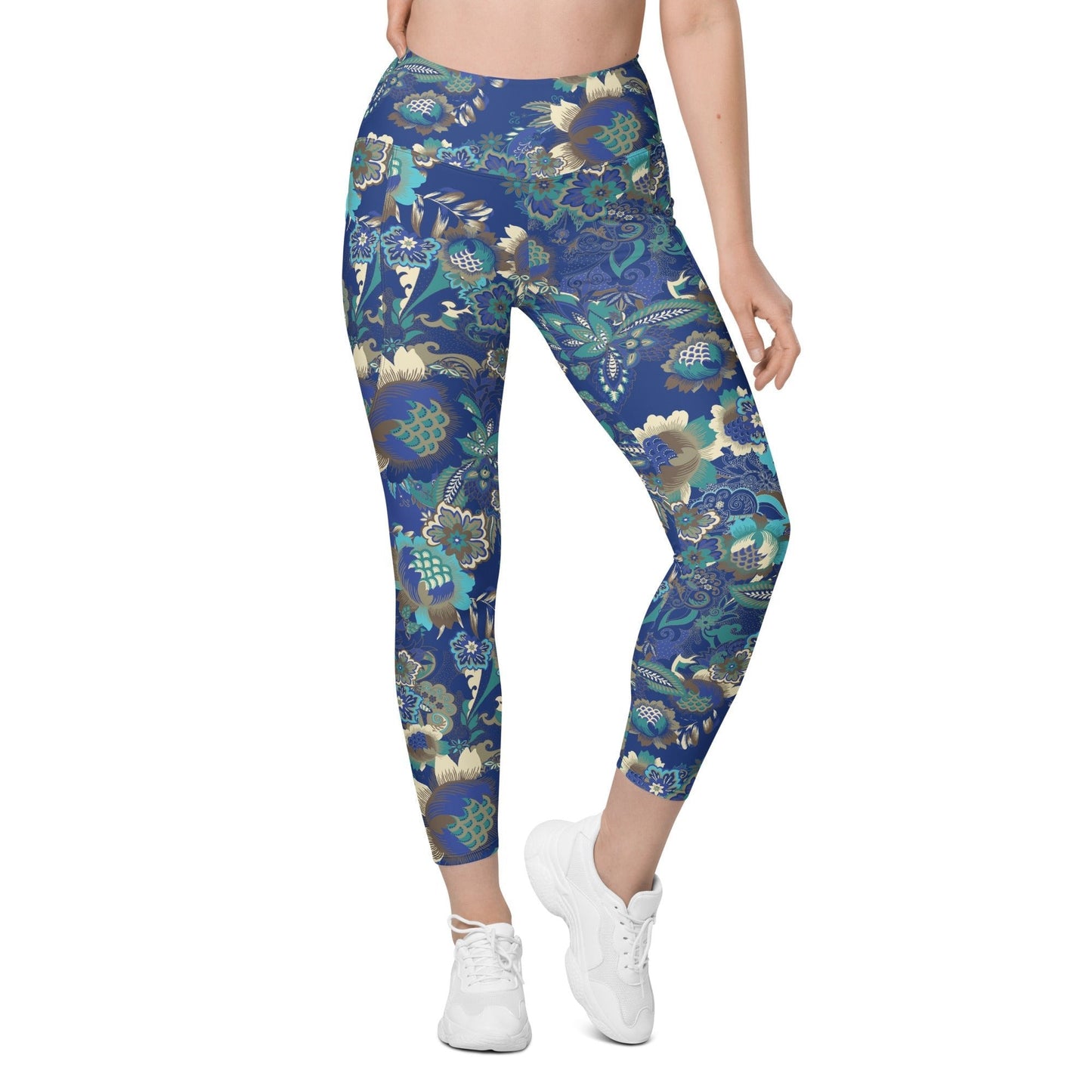 A model wearing the Rio Sculpt Leggings in the bright blue floral print, showing the flattering high-waisted fit and side pocket detail.