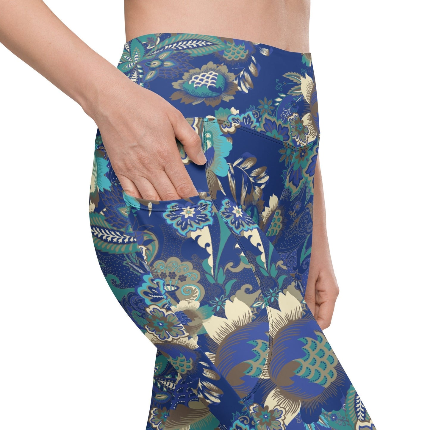 A model wearing the Rio Sculpt Leggings in the bright blue floral print, showing the flattering high-waisted fit and side pocket detail.