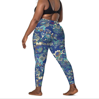 A model wearing the Rio Sculpt Leggings in the bright blue floral print, showing the flattering high-waisted fit and side pocket detail.