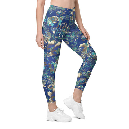 A model wearing the Rio Sculpt Leggings in the bright blue floral print, showing the flattering high-waisted fit and side pocket detail.