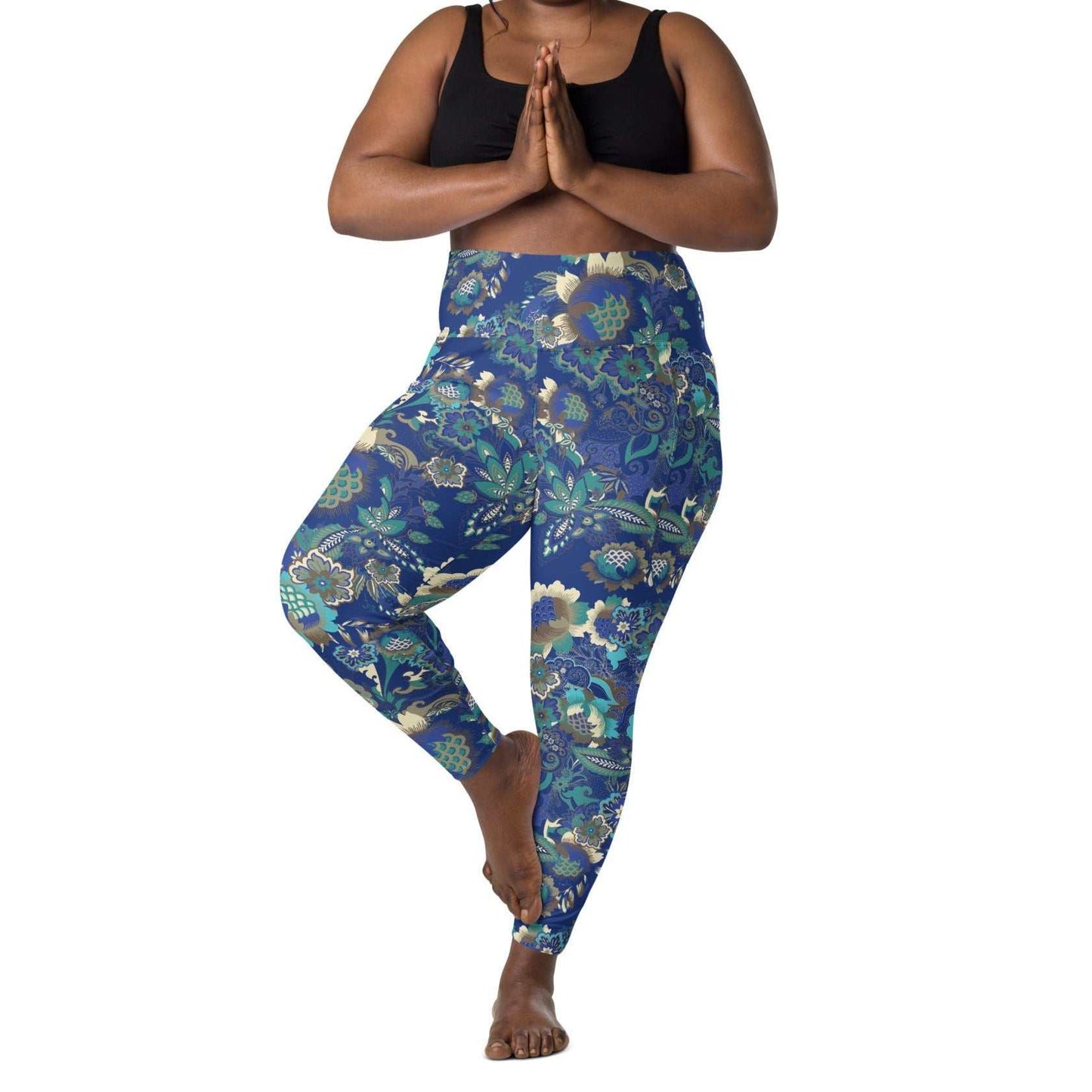 A model wearing the Rio Sculpt Leggings in the bright blue floral print, showing the flattering high-waisted fit and side pocket detail.