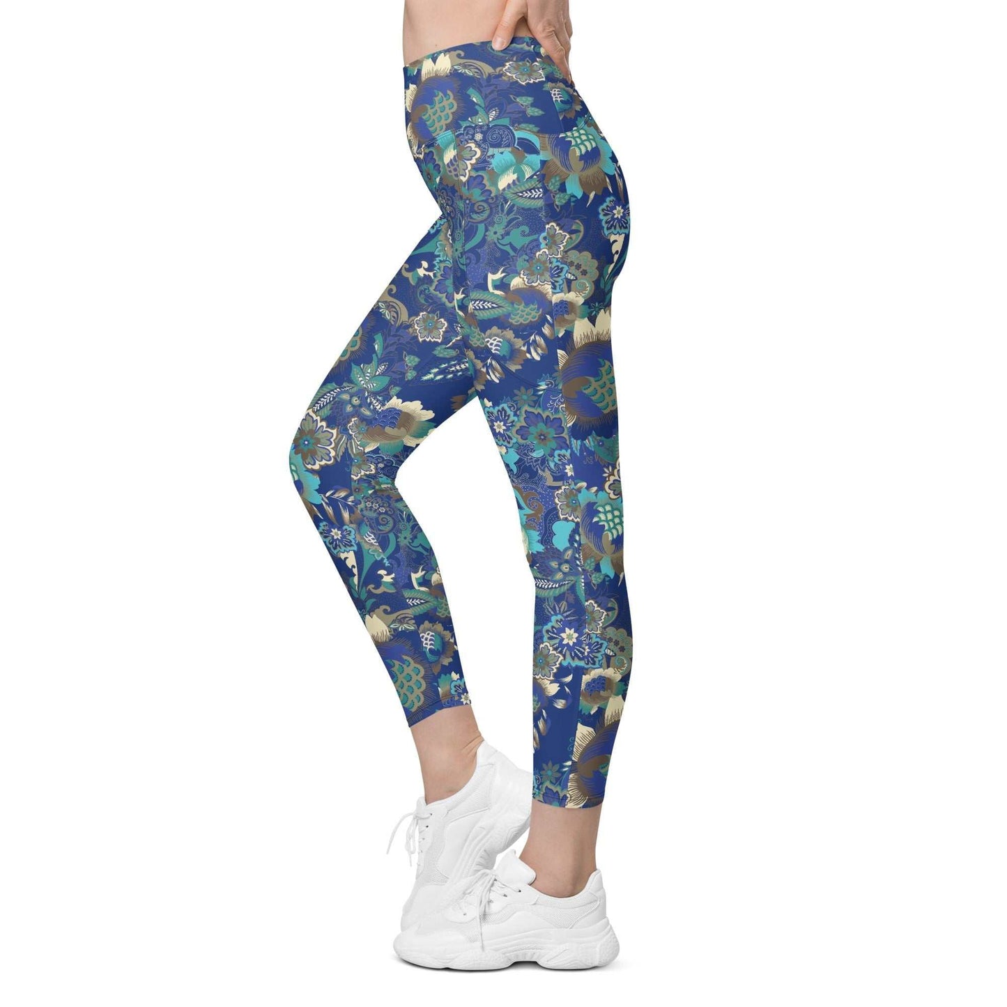 A model wearing the Rio Sculpt Leggings in the bright blue floral print, showing the flattering high-waisted fit and side pocket detail.