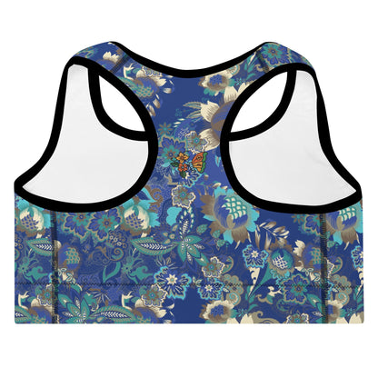 A close up of The Rio Performance Bra, showing the supportive fit and the vibrant bright blue floral print with a butterfly on the back.Highlights the garment's construction from 74% recycled polyester.