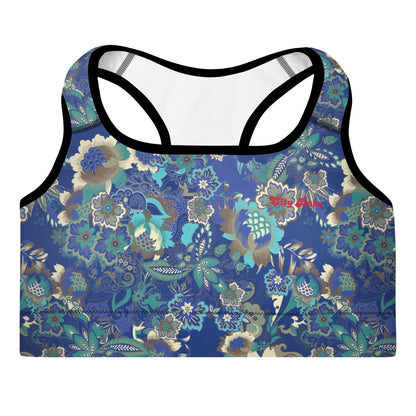 Close-up of the Rio Performance Bra, showing the supportive fit and the vibrant bright blue floral print with City Babe on the top left. Highlights the garment's construction from 74% recycled polyester.