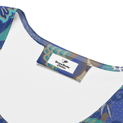 The rio performance tank. a sleeveless athletic tank top with a detailed botanical and floral pattern in navy blue, teal, and gold, paired with dark gray leggings, against a plain white background.