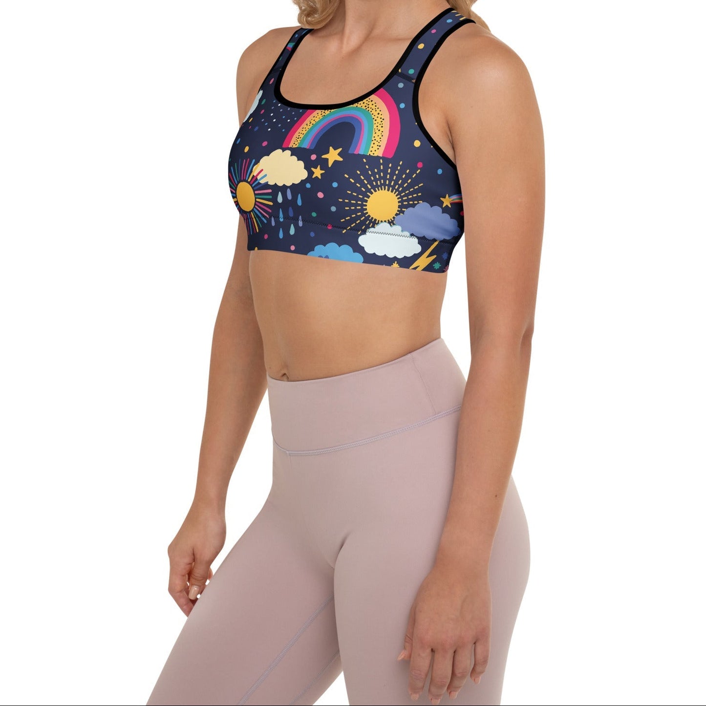 A model wearing the Riverside Performance Bra showcasing the dreamlike print of clouds, stars and rainbows on navy blue background 