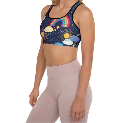 A model wearing the Riverside Performance Bra showcasing the dreamlike print of clouds, stars and rainbows on navy blue background 