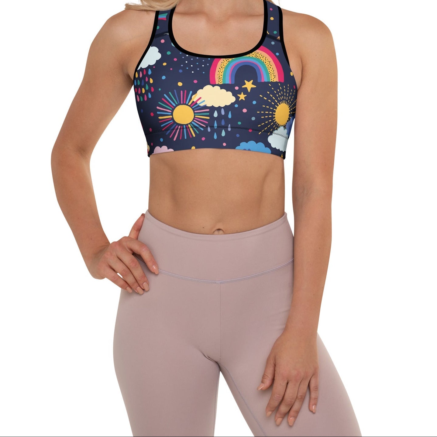 A model wearing the Riverside Performance Bra showcasing the dreamlike print of clouds, stars and rainbows on navy blue background 