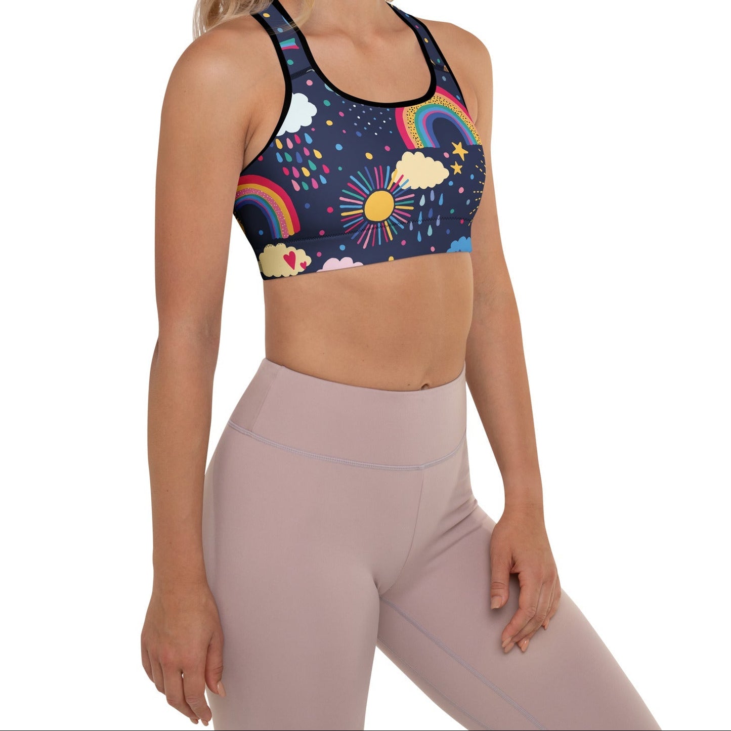 A model wearing the Riverside Performance Bra showcasing the dreamlike print of clouds, stars and rainbows on navy blue background 