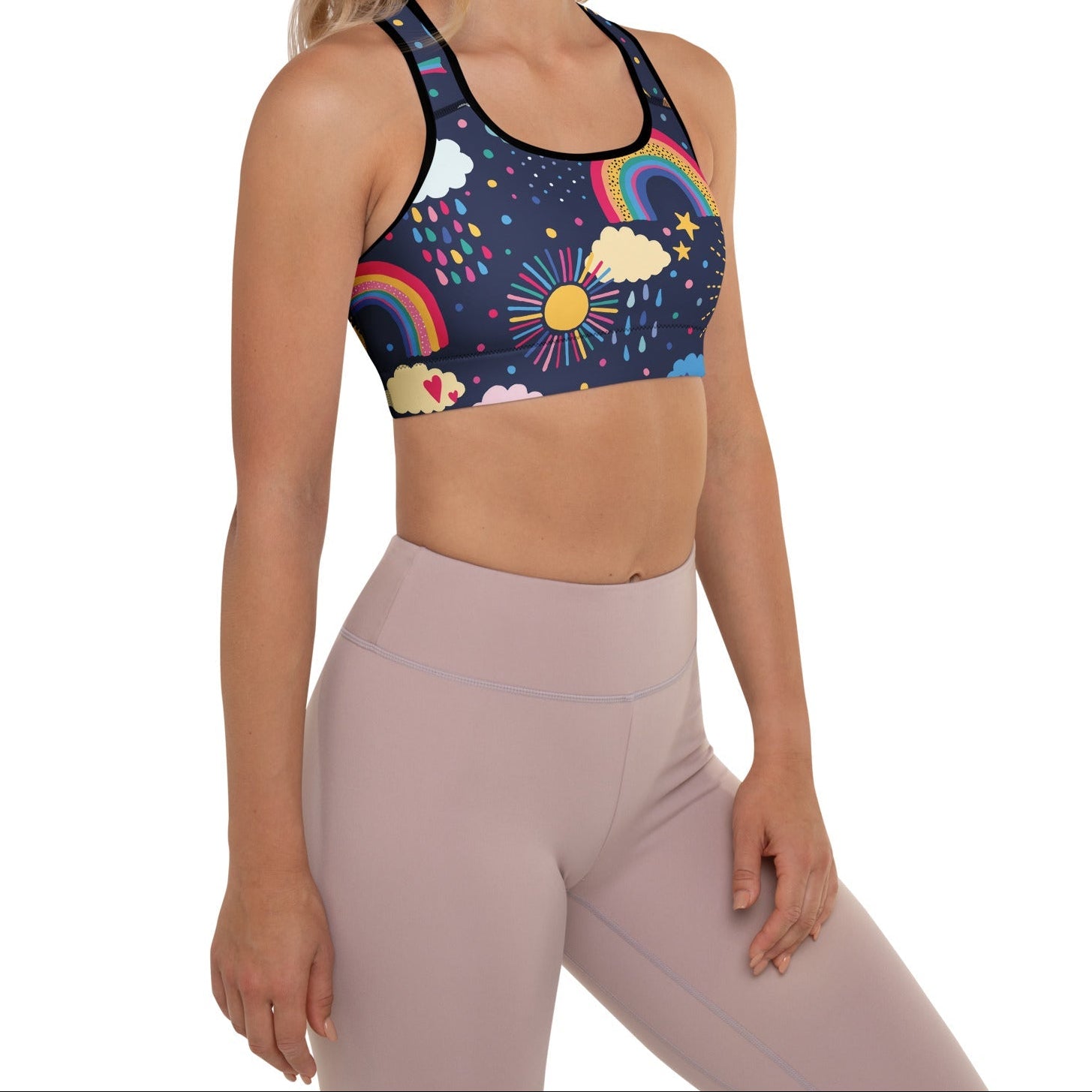 A model wearing the Riverside Performance Bra showcasing the dreamlike print of clouds, stars and rainbows on navy blue background 
