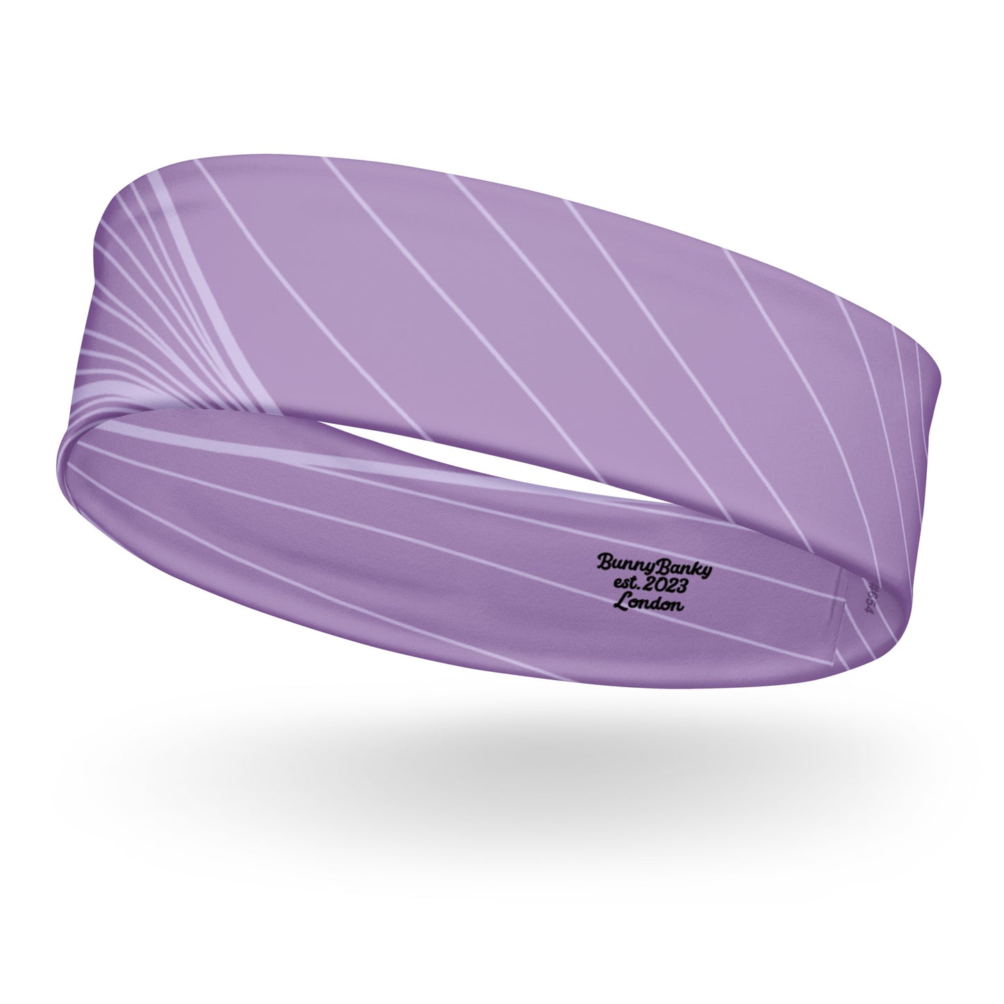 The Roma Headband. A lavender purple athletic headband with a white diagonal stripe pattern and black embroidered text reading 'BunnyBanky est. 2023 London' on a white background.