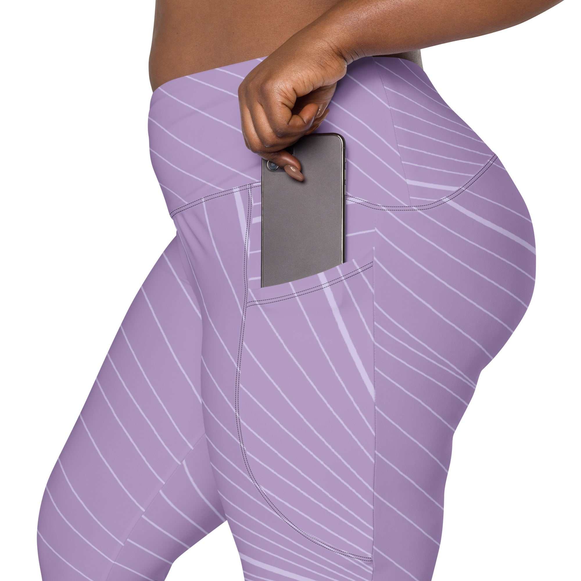 The Roma Sculpt Leggings in light lilac with graphic spiral print and deep side pocket holding a phone