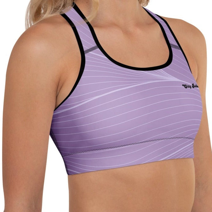 A model wearing the Roma Performance Bra, showing the supportive fit, racer back design, and the graphic spiral lines in motion on the soft light lilac background.