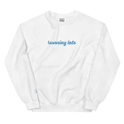 A close-up of The Running Late Sweatshirt, highlighting the "Running Late" embroidery and the iconic heart logo on the sleeve.