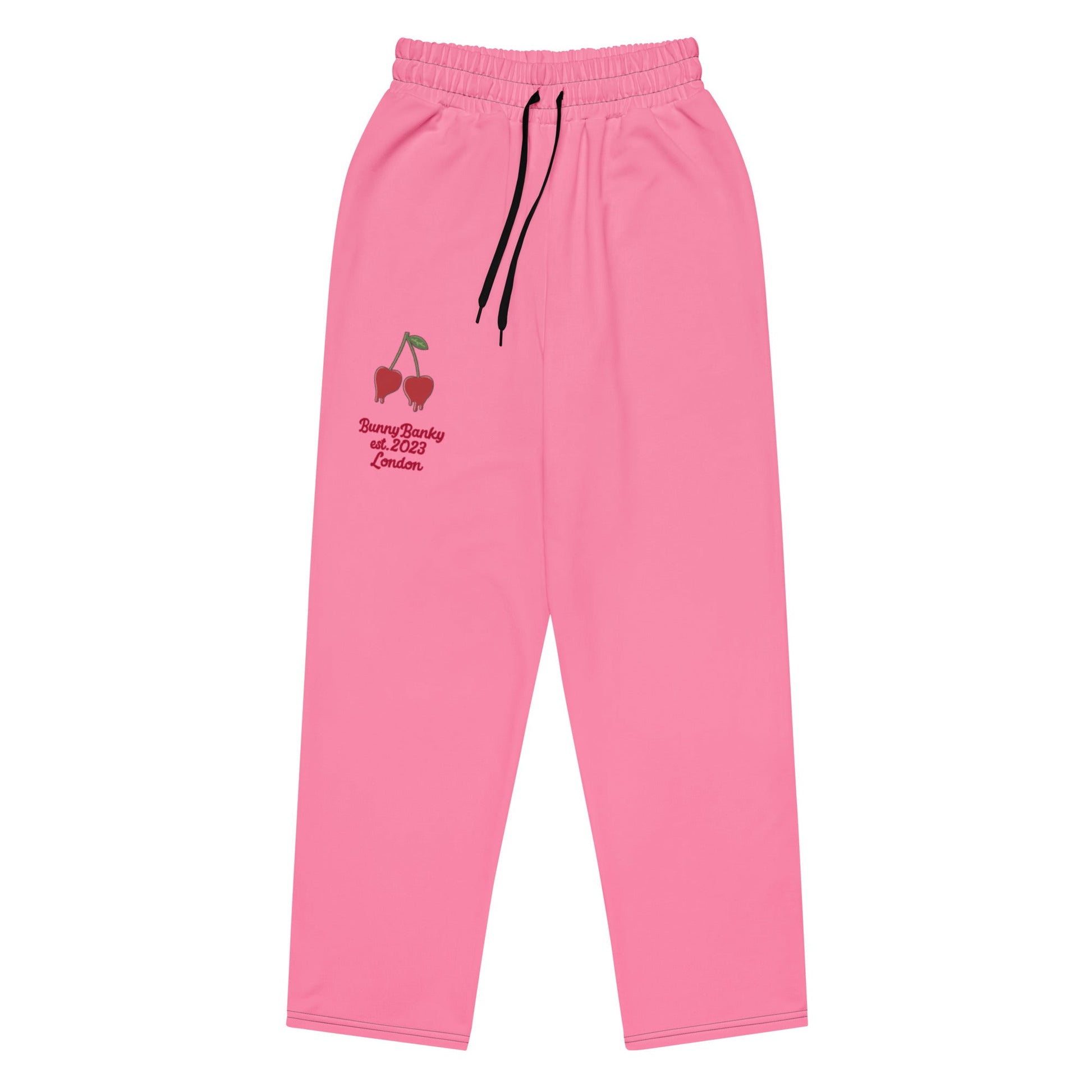 A close-up of The Seoul Pink Flow Wide Joggers, highlighting the playful Pop Cherry print, heritage logo, and the binary code pattern on the back left leg.