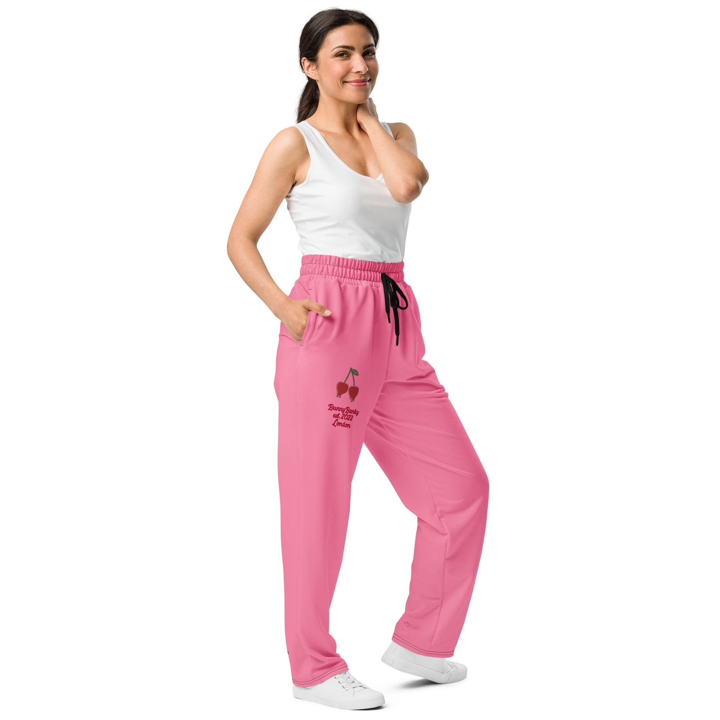 A model wearing The Seoul Pink Flow Wide Joggers, showing the wide-leg cut and the playful Pop Cherry print and binary code on the vibrant pink fabric.