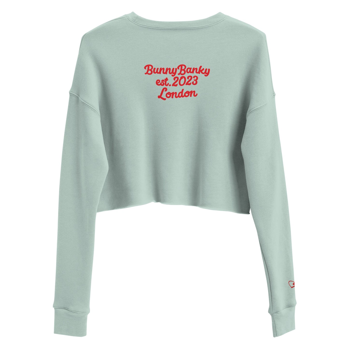 A close-up of The Sisterhood Crop Sweatshirt, highlighting the premium embroidery of the "Female Culture" motto, and signature print at the back and the soft, ring-spun cotton fabric texture.