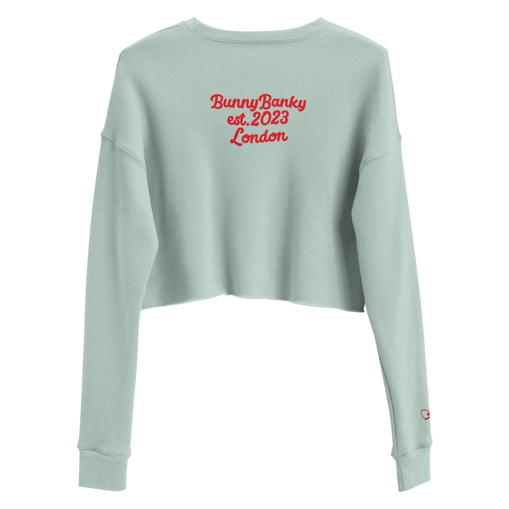 A close-up of The Sisterhood Crop Sweatshirt, highlighting the premium embroidery of the "Female Culture" motto, and signature print at the back and the soft, ring-spun cotton fabric texture.