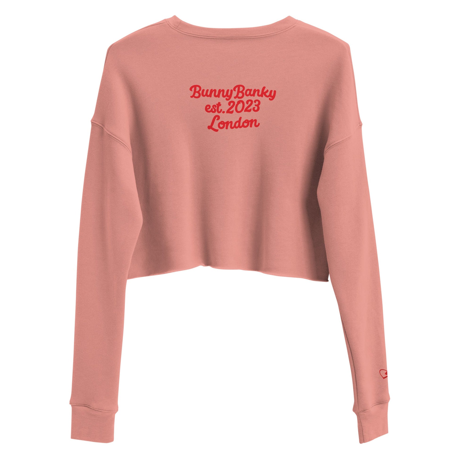 A close-up of The Sisterhood Crop Sweatshirt, highlighting the premium print of the heritage signature at the back and the soft, ring-spun cotton fabric texture.