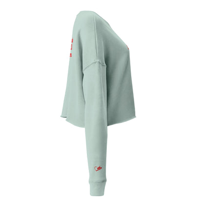 A close-up of The Sisterhood Crop Sweatshirt, highlighting the premium embroidery of the "Female Culture" motto and the soft, ring-spun cotton fabric texture, and iconic heart logo embroidered on the sleeve