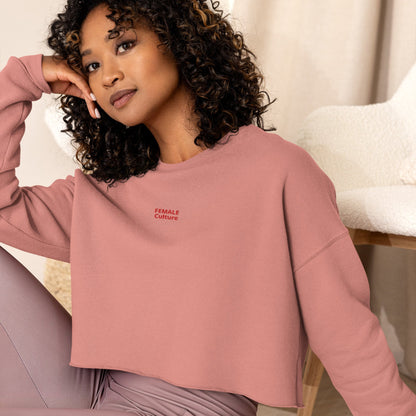 A model wearing The Sisterhood Crop Sweatshirt, showing the raw hem, dropped shoulder cut, and the embroidered "Female Culture" motto on the chest.