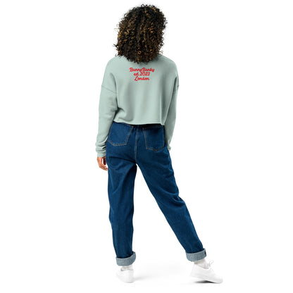 A model wearing The Sisterhood Crop Sweatshirt, showing the raw hem, dropped shoulder cut, and the embroidered "Female Culture" motto on the chest and heritage signature printed at the back